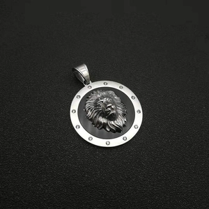 Detail of silver lion head pendant with embossed mane and sparkling zircon circle