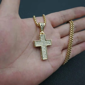 Close-up of gold-plated hip-hop cross pendant with micro-pave cubic zirconia crystals