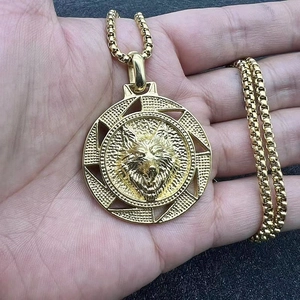 Gold Viking wolf head pendant necklace with Celtic sunburst relief on a long box chain