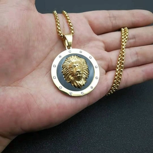 Macro shot of gold lion head pendant with black disc and sparkling crystal accents