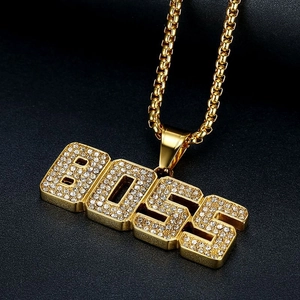 Gold-plated hip hop BOSS pendant necklace with pavé crystal inlay on black surface