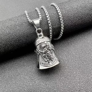Detail of Saint Christopher guardian bell pendant with intricate embossed silver finish