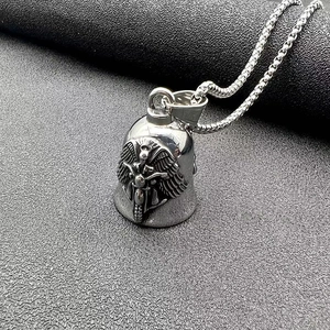 Macro view of retro stainless steel biker bell pendant with embossed wings and motorcycle