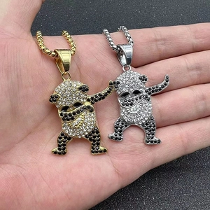 Gros plan détaillé des pendentifs panda dabbing en or et argent avec strass scintillants