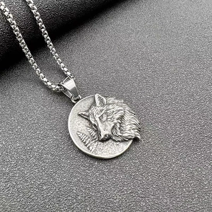 Detail of vintage Viking wolf head pendant with 3D forest texture on box chain necklace