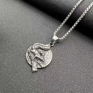 Close-up of vintage titanium steel Viking wolf pendant with detailed relief carving