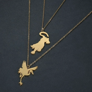 Macro detail of gold plated stainless steel tiger and crane pendants on fine O-chains