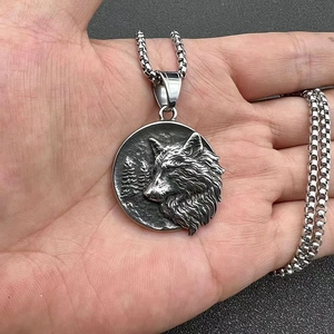 Macro shot of vintage Viking wolf head pendant with thick stainless steel box chain