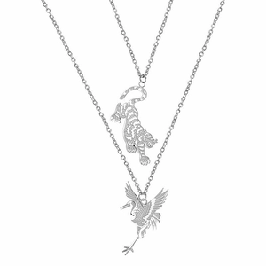 Detailed view of silver tiger and crane pendants on delicate stainless steel chains