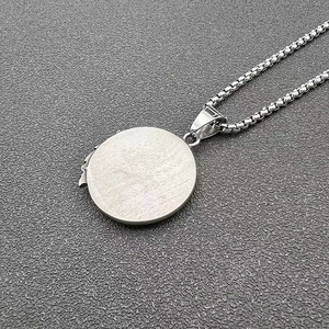 Close-up of wolf pendant back with brushed steel finish and durable box chain