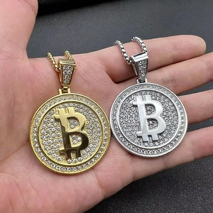 Dettaglio del ciondolo Bitcoin dorato con cristalli scintillanti su catena a maglia