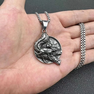 Detailed relief of a Viking squirrel pendant in vintage steel held by hand