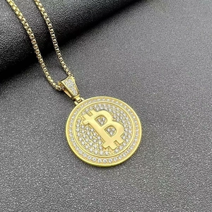 Dettaglio del ciondolo Bitcoin dorato con cristalli scintillanti su catena box