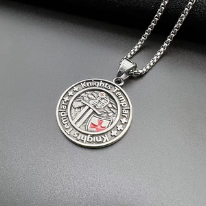 Close-up of vintage Knights Templar pendant with red enamel cross on steel chain