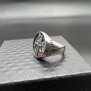 Detailed view of silver knight ring with red cross and Knights engraving on the side