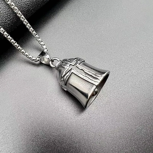 Close-up of retro punk steel bell pendant with embossed cross and box chain link