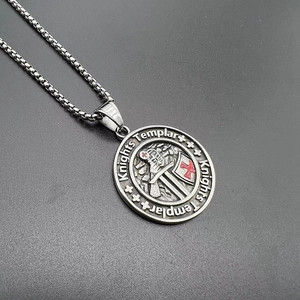 Detailed close-up of a Knights Templar vintage steel pendant with red cross engraving