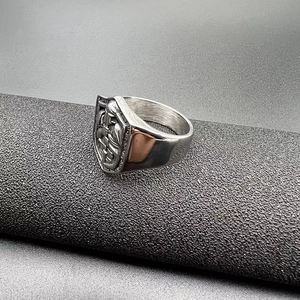 Detailed close-up of a vintage knight's shield crest embossed on a silver steel ring