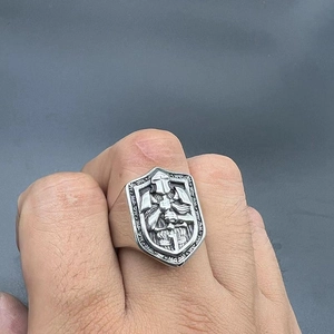 Macro view of vintage shield-shaped knight ring featuring detailed medieval armor relief