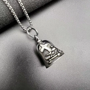 Detailed macro view of punk biker bell pendant with cross and skeleton skull engraving