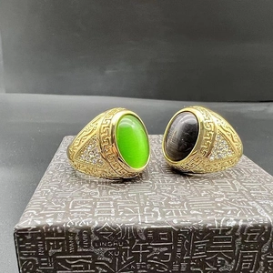 Detailed close-up of gold-plated hip-hop rings with cat-eye stones and rhinestones