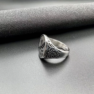 Macro shot of vintage steel ring featuring crossed swords and floral embossed details