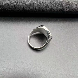 Macro shot of polished stainless steel ring with vintage engraved side floral patterns