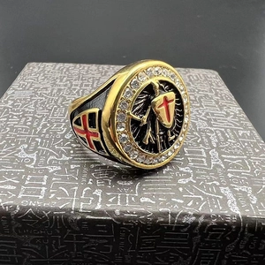 Close-up of gold Knights Templar ring with red cross emblem and white zircon inlay