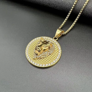 Detail of gold lion head medallion with rhinestone bezel and textured grid background