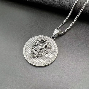 Macro shot of silver lion head pendant with rhinestone border and square box chain