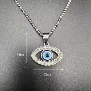 Detail shot of iced out Evil Eye pendant with 34x32mm dimensions in gold plating