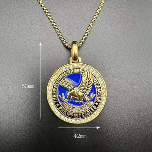 Close-up of golden eagle pendant with blue enamel, white zircons, and dimensions 53mm x 42mm