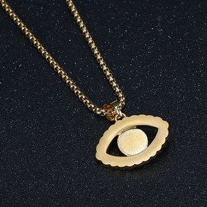 Gold plated hip hop necklace with evil eye pendant on a star-like black background