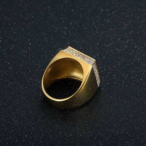 Luxury gold square signet ring for men with micro-pave crystals on a black background