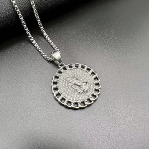 Detailed close-up of a silver prayer hands pendant necklace with iced-out rhinestones