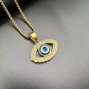 Close-up of gold-plated Evil Eye pendant necklace with sparkling crystal inlay details