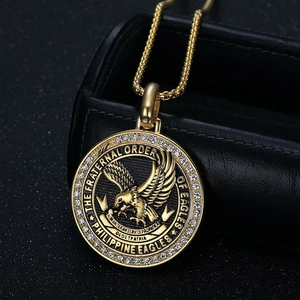 Macro detail of gold eagle pendant with white crystals and Philippine Eagles engraving