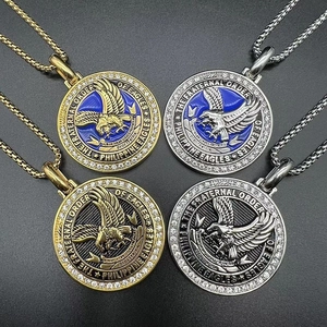 Detailed view of four round eagle crest pendants with blue enamel and rhinestone edges