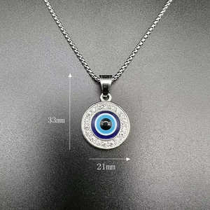 Detailed size view of evil eye pendant measuring 33mm by 21mm on a silver chain