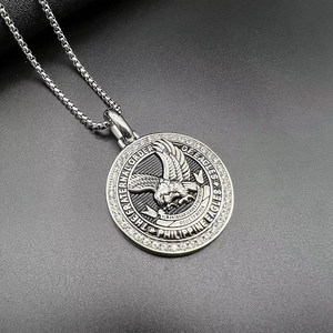 Macro shot of stainless steel eagle medallion pendant with embedded sparkling crystals