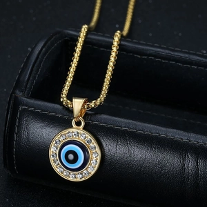Golden Evil Eye pendant necklace with blue enamel and sparkling crystals on ball chain
