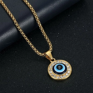 Golden Evil Eye pendant necklace with blue enamel and sparkling crystal pavé on box chain