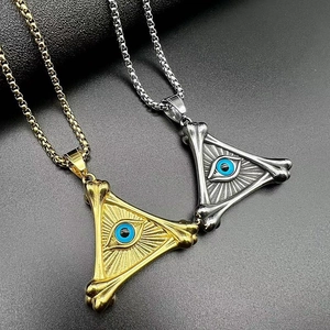 Macro shot of gold and silver triangle Evil Eye necklaces with punk bone textured frames