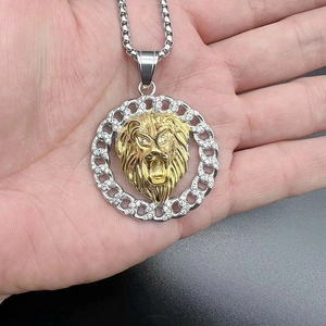 Nahaufnahme eines goldenen Löwenkopf-Anhängers mit weißen Diamanten im silbernen Kranz