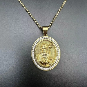Detailed close-up of a gold-plated religious saint pendant with white zircon stones