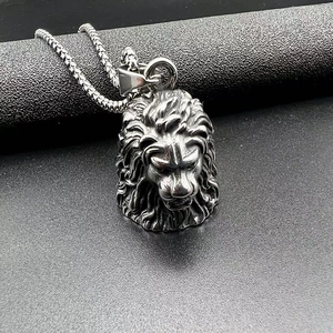 Detailed close-up of a stainless steel lion head pendant on a black textured background