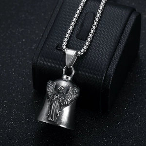 Vintage stainless steel angel wings bell pendant necklace displayed on a black leather box