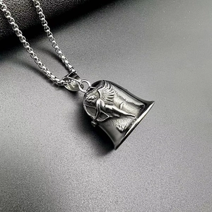 Detail shot of vintage angel relief on a polished steel biker bell pendant with box chain