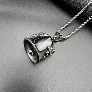 Macro shot of punk biker guardian bell pendant with skull relief in vintage gunmetal finish