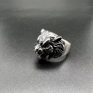 Macro side view of vintage stainless steel ring with detailed tiger head engraving